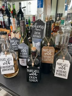 wine bottles with labels on them sitting on a counter in front of other liquor bottles