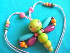 a colorful beaded toy sitting on top of a blue surface