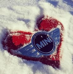 a heart shaped object is covered in snow with the word mnn written on it