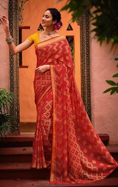 This saree is Ready to Wear (With Fall and Pico Done). Traditional Printed Saree, made up of creative work and graceful fabrics Brasso Comes with 80 cm blouse piece in the saree border Length: 6.30 Meter With Blouse Made up of Pure Fabric Must have saree for your festive collection This saree is a suitable amalgamation of style and grace that is required from ethnic wear. The saree is ideal for any formal gathering. The saree comes with an unstitched blouse of corresponding color and design as s Bandhani Print Pre-draped Saree For Puja, Red Pre-draped Saree With Pallu For Eid, Red Bandhani Print Pre-draped Saree In Art Silk, Bollywood Style Red Pre-draped Saree With Printed Border, Festive Red Pre-draped Saree With Bandhani Print, Red Bandhani Pre-draped Saree, Red Unstitched Saree For Navratri, Bollywood Style Red Pre-draped Saree With Self Design, Red Bandhani Print Unstitched Saree