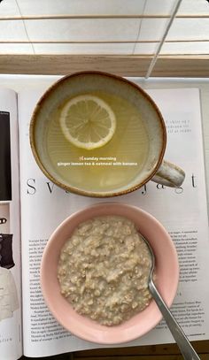 a bowl of oatmeal next to an open book with a lemon slice