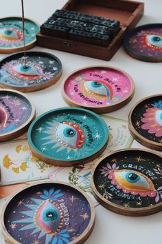 there are many colorful plates on the table with an evil eye painted on one side