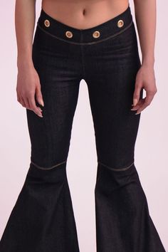 Chance Denim Bell Bottoms Key Features: Dark blue denim Grommet accents at the waistband, back, and bottom flare Zipper detailing at the rear Made in the USA Details: The Chance Denim Bell Bottoms feature dark denim with stitched knee detailing and a dramatic flared cut. Grommets line the waistband and cascade up the flare for a bold, edgy look. Content + Care: Machine wash cold, tumble dry low, no bleach, cool iron only. Size + Fit: The model is wearing a size small. Check our size guide for yo Mid-rise Fitted Denim Blue Flares, Fitted Mid-rise Denim Blue Flares, Fitted High Rise Recycled Denim Pants, Fitted High-rise Pants In Recycled Denim, Spring Dark Wash Flare Jeans, Fitted High Rise Recycled Denim Bottoms, Fitted High-rise Recycled Denim Bottoms, Fitted Mid-rise Recycled Denim Bottoms, Fitted Denim Blue Flares