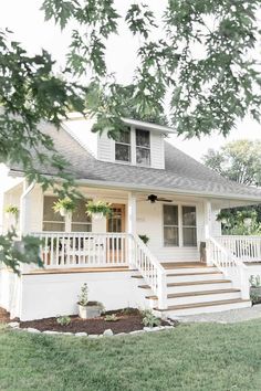 a white house with steps leading up to the front door