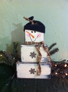 a snowman sitting on top of three boxes