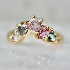 three different colored stones in a gold ring