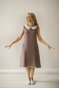 "Our casual sleeveless dress is handcrafted, tailored to the unique body measurements of each customer. We take pride in the fact that no factory processes are involved in its creation. We ensure that every creative and sewing task is fully rewarded. DESCRIPTION This casual sleeveless linen dress has a slight A-line shape, which means it's a bit wider towards the bottom, giving it a flowy feel. The dress has a simple round collar, and it hits just above the knee. There are pockets inside and it A Line Dress Knee Length, Casual Sleeveless Dress, Sleeveless A Line Dress, Peterpan Collar Kurti, A Line Frocks For Women, Sleeveless Frocks For Women, A Line Dress Designs, Sleevless Dresses, Cute Knee Length Dresses