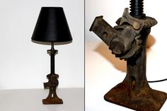 a lamp made out of an old machine parts and a black shade on the floor