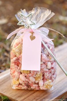 a bag filled with popcorn sitting on top of a wooden table next to a knife