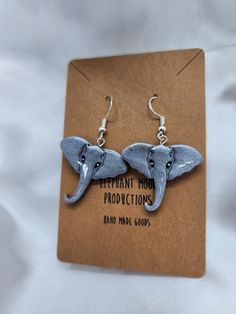 an elephant earring is shown on top of a brown card with the words elephant moon production