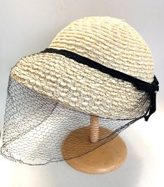 "Vintage 1950s Ladies Straw Hat Beige with Brown Ribbon and Bow , Black Net Veil Fascinator or half skull hat. Original label says  PIKO Paris New York Montreal Nice clean condition. net is also in good condition except for  one small edge section Measures 3 3/4\" tall 22\" front to back, 23\" side to side Inside circumference is 21\"  Weight is 2.6 oz. or 75 grams I am offering several vintage hats , and can combine  purchases to help save on shipping charges. TRACKED SHIPPING IS FREE WITHIN CANADA AND USA We take pride in packing carefully and send out within 1 business day." Vintage Black Straw Hat With Curved Brim, Vintage Black Brimmed Straw Hat, Vintage Black Straw Hat With Short Brim, Vintage Black Straw Hat For Beach, Vintage Black Straw Beach Hat, Vintage Black Adjustable Boater Hat, Vintage Adjustable Black Boater Hat, Vintage Cloche Hat With Curved Brim For Vintage Fashion, Adjustable Curved Brim Hat For Vintage Fashion