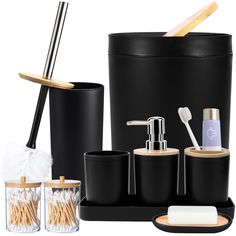 black bathroom accessories including toothbrushes, soap dispenser, and cups