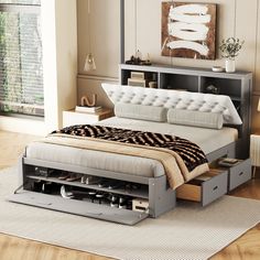 a bed with drawers underneath it in a room