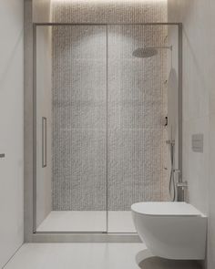 a white bathroom with a glass shower door