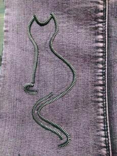 a purple piece of cloth with a cord attached to it