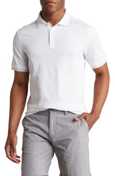 A blend of cotton and CoolMax® performance fabric wicks away sweat and keep you cool in this smart polo styled with a tipped collar. Button half-placket Spread collar Short sleeves 51% cotton, 49% CoolMax® polyester
 Machine wash cold, lay flat to dry Imported Model stats: 6'1" height, 32" waist. Model is wearing size Medium. Fitted Polo Shirt With Ribbed Collar For Golf, White Cotton Polo Shirt With Contrast Trim, White Sporty Polo Shirt With Contrast Collar, Sporty Fitted Polo Shirt With Contrast Collar, White Collared Polo Shirt With Contrast Trim, White Polo Shirt With Contrast Trim, White Sporty Polo Shirt With Contrast Trim, Sporty White Polo Shirt With Contrast Trim, Fitted Sporty Polo Shirt With Contrast Trim