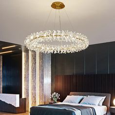 a bedroom with a large bed and a chandelier hanging from the ceiling above it