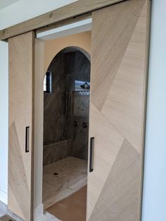 an open door leading to a walk in shower