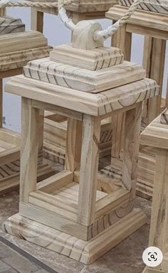 several wooden stools and tables with rope on the top one is made out of wood