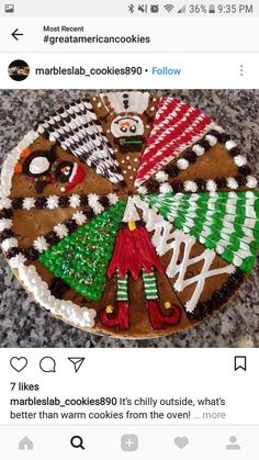 a cookie decorated like a christmas tree on top of a counter next to an instagram post