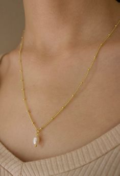 This freshwater pearl necklace is a perfect gift. This ball chain necklace with a freshwater pearl is an elegant pairing necklace that is gold plated. Handmade Necklace Length: 20 inches Necklace Pedant Length of pearl: Each pearl is uniquely sized between 0.4''-0.65‘’ in length, 0.1''-0.4'' in width. **Pearl is unique, so there is some variation in size and color but the same level of quality is guaranteed. Necklace Material: Gold Plated Recommended: Remove Jewelry before showering for lasting Gold Plated Ball Chain Necklace Gift, Dainty Gold Chain Necklace With Pearl Drop, Gold Pearl Charm Necklace With Pearl Drop, Gold Pearl Drop Charm Necklace, Pearl Pendant Chain Necklace With Pearl Chain, Gold Pearl Drop Chain Necklace, Gold-plated Ball Chain Necklace, Perfect As A Gift, Gift Pearl Necklace With Satellite Chain, Gold Pearl Charm Necklace With Delicate Chain