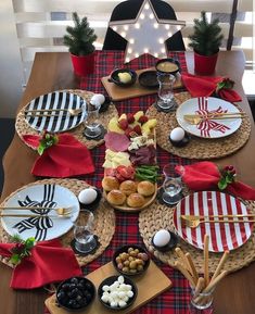 the table is set with plates, bowls and utensils for an elegant holiday feast