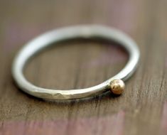 Simple 14k yellow gold pebble on a rustic sterling silver band ring. The ring is hammered, textured to look unique, organic and rustic!  The listing is for one pebble ring. The last image shown with three rings gives you an idea of the size when worn.  The gold and silver are both 100% recycled. No mines were harmed in obtaining the precious metal.  You can request the silver to be oxidized. The dark oxidation eventually wears off, giving the ring even more character and distinction or you can request it to be left unoxidized. Please indicate when you check out. Pebble Ring, December Birthstone Ring, Summer Rings, How To Make Rings, Sterling Silver Rings Bands, Cabochon Ring, Toe Ring, Rings Cool, Silver Band Ring