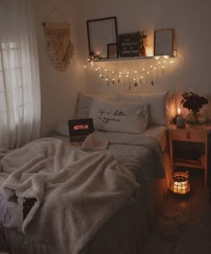 a bedroom with lights strung above the bed