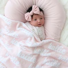 a baby wrapped up in a pink blanket