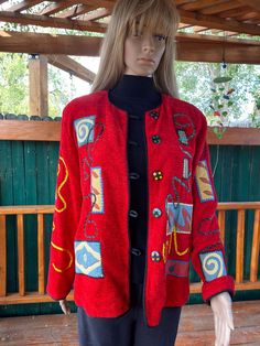 Beautiful, vibrant red jacket, with several large round polka dots buttons closing down the front. Round neck, long sleeves, entirely lined in black. Very colorful patches of different designs are sewn all over the jacket, making it quite unique. Trimmed in black rope  all over. Excellent condition. Size about Medium, but please check the measurements below.  Bust :  40"  Length from shoulder : 25"   Length of sleeves from shoulder : 23.5"   Width at bottom : 40" (it falls straight)     Neck opening : 22" Jacket Making, Black Rope, Red Jacket, Vibrant Red, Bright Red, Favorite Outfit, Polka Dots, Round Neck, Bathing Beauties