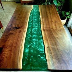 two wooden tables with green water in the center and one is made from wood planks