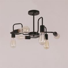 a black chandelier with five light bulbs