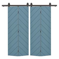 two blue shutters with metal handles on each side and an arrow design in the middle