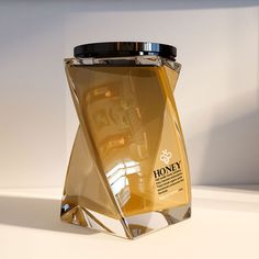 a bottle of honey sitting on top of a table next to a white countertop