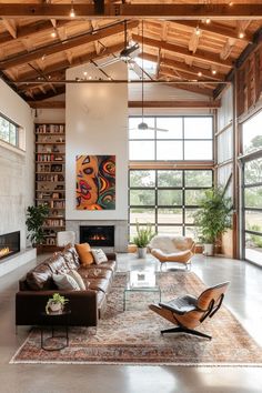 a living room filled with furniture and a fire place in the middle of an open floor plan