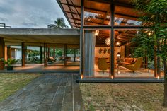 an open living room and dining area with glass walls