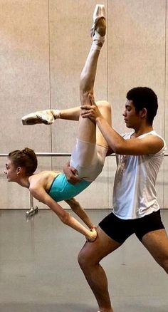 two people doing acrobatic tricks in a dance studio