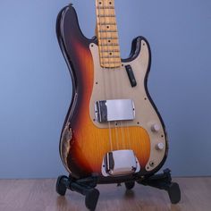 an electric guitar sitting on top of a wooden table