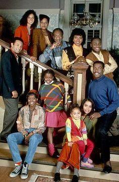 a group of people are posing on the stairs