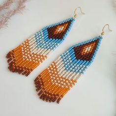 These long beaded earrings are inspired by native American patters. Handcrafted with meticulous attention to detail, they exude timeless sophistication. Perfect for adding a touch of celestial charm to any ensemble, these earrings are sure to become a cherished addition to your jewelry collection. Dimensions: - Length: 10 cm (3.9 inches) - Width: 3 cm (1.2 inches) Bohemian Long Drop Beaded Earrings With Dangling Beads, Bohemian Large Beaded Dangle Earrings, Bohemian Long Drop Chandelier Earrings With Dangling Beads, Bohemian Beaded Long Drop Earrings, Bohemian Teardrop Earrings With Large Beads, Bohemian Long Drop Chandelier Earrings, Bohemian Dangle Earrings With Large Beads, Southwestern Style Beaded Dangle Earrings For Festival, Southwestern Style Dangle Beaded Earrings For Festivals