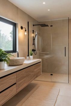 a bathroom with a sink, shower and large window in it's center area