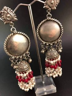 Looks Grabbing Jewelry Silver Plated Earrings to complete your stunning looks. We provide vast variety of designs that flaunt your style Two colour of pairs of extremely charming, silver-colored metal earrings with beautiful tassels - pearls and red or green beads. Length 10 cm, diameter 3.5 cm. OCCASION : Traditional Wear, Party Wear, Collage Wear COLOR : Silver SUBCATEGORY : Jhumka Earring DESIGN : Floral Design MAKE : Handmade PLATING : Silver Plating READY TO SHIP : Yes PACKAGE CONTENTS : 1 Traditional Dual-tone Danglers, Festive Metal Temple Jewelry Chandbalis, Chandbali Jhumkas With Latkans For Puja, Festive Dual-tone Earrings For Puja, Navratri Latkans Jhumka Drop Earrings, Navratri Jhumkas With Latkans, Festive Metal Chandbalis, Festive Round Metal Chandbalis, Temple Jewelry Metal Chandbalis For Festivals