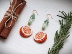 Introducing our vibrant Orange Fruit Earrings! handcrafted and  embroidered, these earrings are made from high-quality materials. They showcase the beauty of natural stones like aventurine and glass beads, beaded in a bright and modern design. With their playful charm and impeccable craftsmanship, these earrings are a must-have accessory! These beaded citrus earrings can be a great gift for those who loves nature. The back side is made from orange eco suede, it's soft and pleasant for the touch. The ear wires are made from the brass and covered 14k gold. They are hypoallergenic.   Size inches: Length inches - 1.97 (5 cm) Width inches - 0.98 (2.5 cm) Orange Natural Stone Drop Earrings, Orange Natural Stones Drop Earrings, Orange Beaded Earrings For Summer Gift, Summer Orange Beaded Earrings As Gift, Summer Orange Jewelry With Fruit Design, Handmade Orange Beaded Earrings As Gift, Orange Beaded Earrings As A Gift, Orange Fruit Design Earrings As Gift, Festive Handmade Orange Earrings