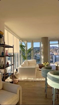 a living room filled with furniture and lots of windows next to a large window sill