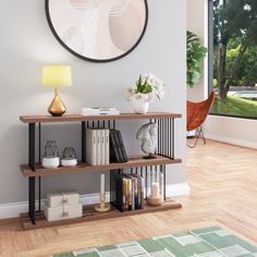 a living room with a large window and a book shelf in front of the wall