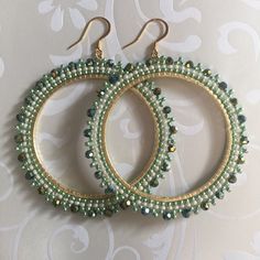 Extra Large Seed Bead Hoop Earringsp Hoop earrings made with metallic lime green and cream colored 11/0 beads with beautiful dual gold and green coated a/b Czech beads. The mixture of tones create a rich bright warm weather pallette. The french hook earwires and findings are 14kt gold plated. These very large very lightweight earrings measure approximately 3 inches (7.62cm) total. The beaded hoops are slightly over 2.5 inches (6.35cm). Great for anytime. You will absolutely love this color and s Handmade Green Hoop Earrings For Party, Elegant Gold Hoop Earrings With Colorful Beads, Green Jewelry With Tiny Beads, Elegant Green Beaded Earrings With Gold Beads, Green Round Jewelry With Tiny Beads, Green Hoop Earrings With Tiny Beads, Green Beaded Hoop Earrings For Gift, Green Hoop Beaded Earrings With Dangling Beads, Green Round Beads Hoop Earrings For Festivals