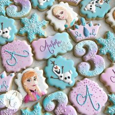 frozen princess cookies decorated with royal icing and fondant numbers are displayed on a table