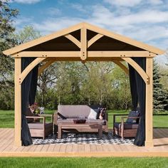 a wooden gazebo sitting on top of a lush green field