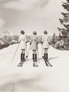 three women standing on skis in the snow