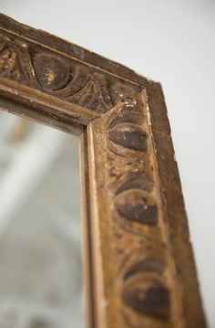 an old mirror is shown with the reflection of it's own face on it